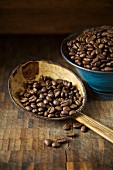 Organic coffee beans on a rustic spoon