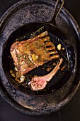 Lamb chops with garlic and thyme in a cast iron pan