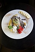 Sweet crepes with pistachio ice cream, bananas and chocolate