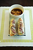 Vietnamese spring rolls with sausage and peanut sauce