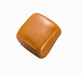A caramel on a white surface (close-up)