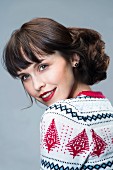 Dark-haired woman wearing festive knitted sweater