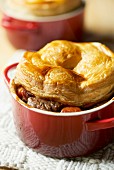 A beef pie with a puff pastry lid