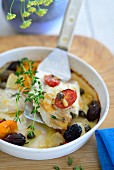 Oven-baked haddock with capers, olives and thyme