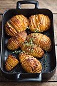 Hasselback potatoes in a roasting tin