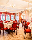 Red medallion chairs in grand, festive dining room