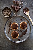 Chocolate tartlets on a metal tray (seen from above)