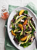 Chicken salad with avocado and grilled peach wedges