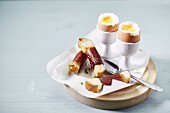 Soft boiled eggs and bacon-wrapped soldiers for breakfast