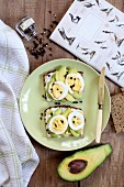 Slices of bread topped with avocado, egg and pepper