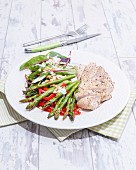 Chicken and asparagus salad with peppers and pine nuts