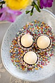 Marzipan eggs with chocolate glaze and sugar sprinkles for Easter