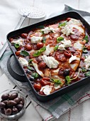 Plaice with tomatoes, mozzarella, basil and olives