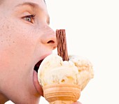 Junge leckt an Eis in Waffel, close up