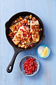 Fried carp with a honey and lemon sauce, almonds and pomegranate seeds