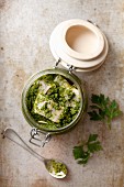 Herring with salsa verde in a preserving jar