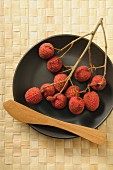 Lychees on a sprig on a plate
