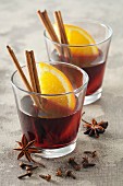Mulled wine with spices and orange wedges