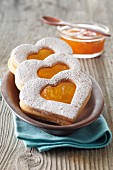 Heartshaped biscuits with apricot jam