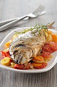 Fried sea bream on a bed of vegetables