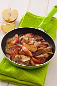 Pork fillet with apple wedges, red onions and mushrooms