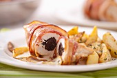 Chicken breast wrapped in bacon filled with plums