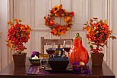 Table set for two autumnally decorated with pumpkin and berries