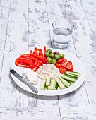 A selection of raw Mediterranean vegetables with a dip