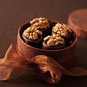 Walnut and marzipan pralines in a round gift box