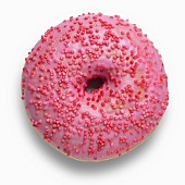 A pink doughnut decorated with red sugar sprinkles