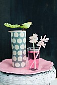 Drinking straws with paper collars and pink drink in glass