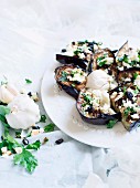 Baked aubergines with garlic, cheese, parsley and raisins