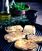 Halloumi cheese with rosemary on a barbecue