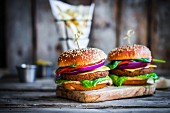 Homemade burgers on rustic wooden surface