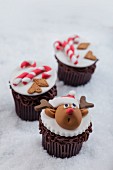 Chocolate cupcakes decorated with reindeer and candy canes for Christmas