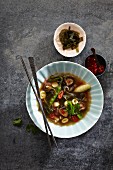 Mushroom stock with mange tout, strips of kombu seaweed, bamboo sprouts and coriander (Japan)