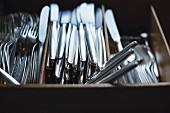 Silver cutlery in a cutlery box in a restaurant