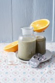 A charcoal smoothie with oranges and bananas