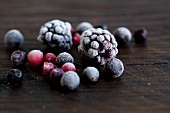 Frozen forest berries on a wooden surface