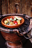 A plate of chicken and vegetables on a grill, Marrakesh, Morocco