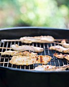 Satay skewers on a barbecue