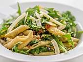Pasta salad with rocket, dried tomatoes and Parmesan cheese (close-up)