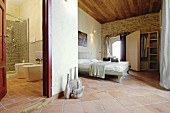 Mediterranean bathroom and bedroom with terracotta floor tiles