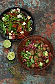 Chilli con carne salad with meatballs and peperonata salad with feta cheese and rocket