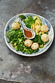 Avocado and pea salad with sticky rice balls and a miso dressing