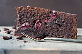 A slice of chocolate cake with sour cherries (close-up)