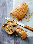 A bread roll filled with ham, cheese and courgette