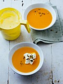 Velvety carrot soup with lemon cream and pumpkin seeds