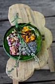 Dried medicinal herbs in a green ceramic bowl