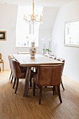Wooden table and leather-covered chairs in classic dining room